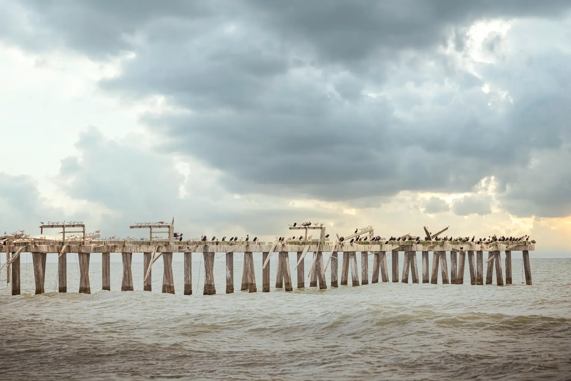 Old Naples Pier under cloudy sky