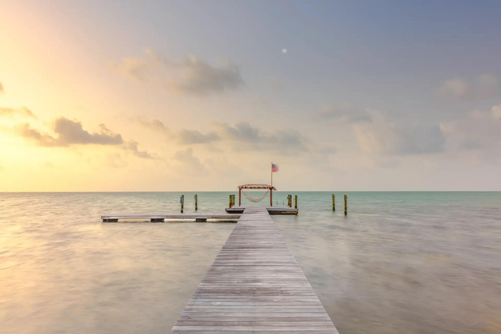 Serene dock at sunset over water