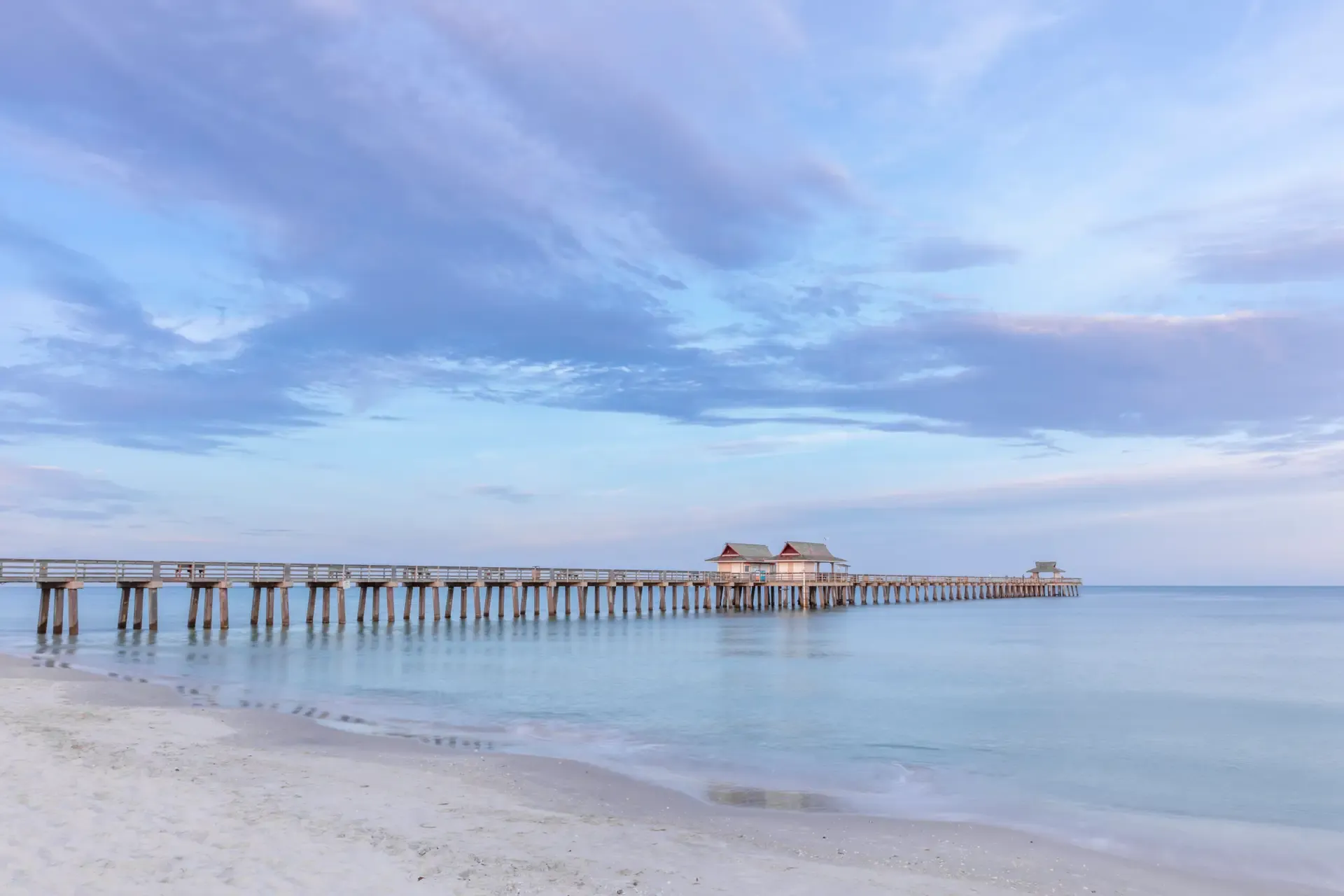 Serene naples pier under a blue sky