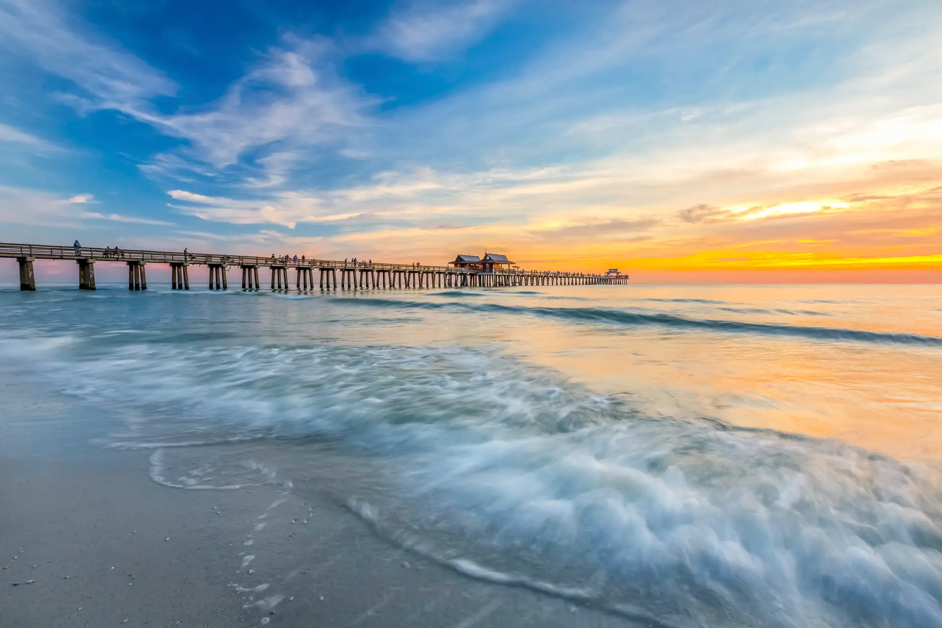 Sunset over tranquil ocean pier