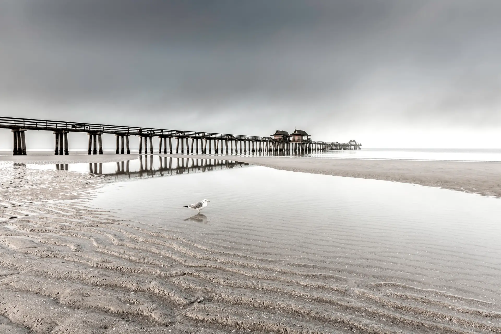 Serene pier with calm water reflections