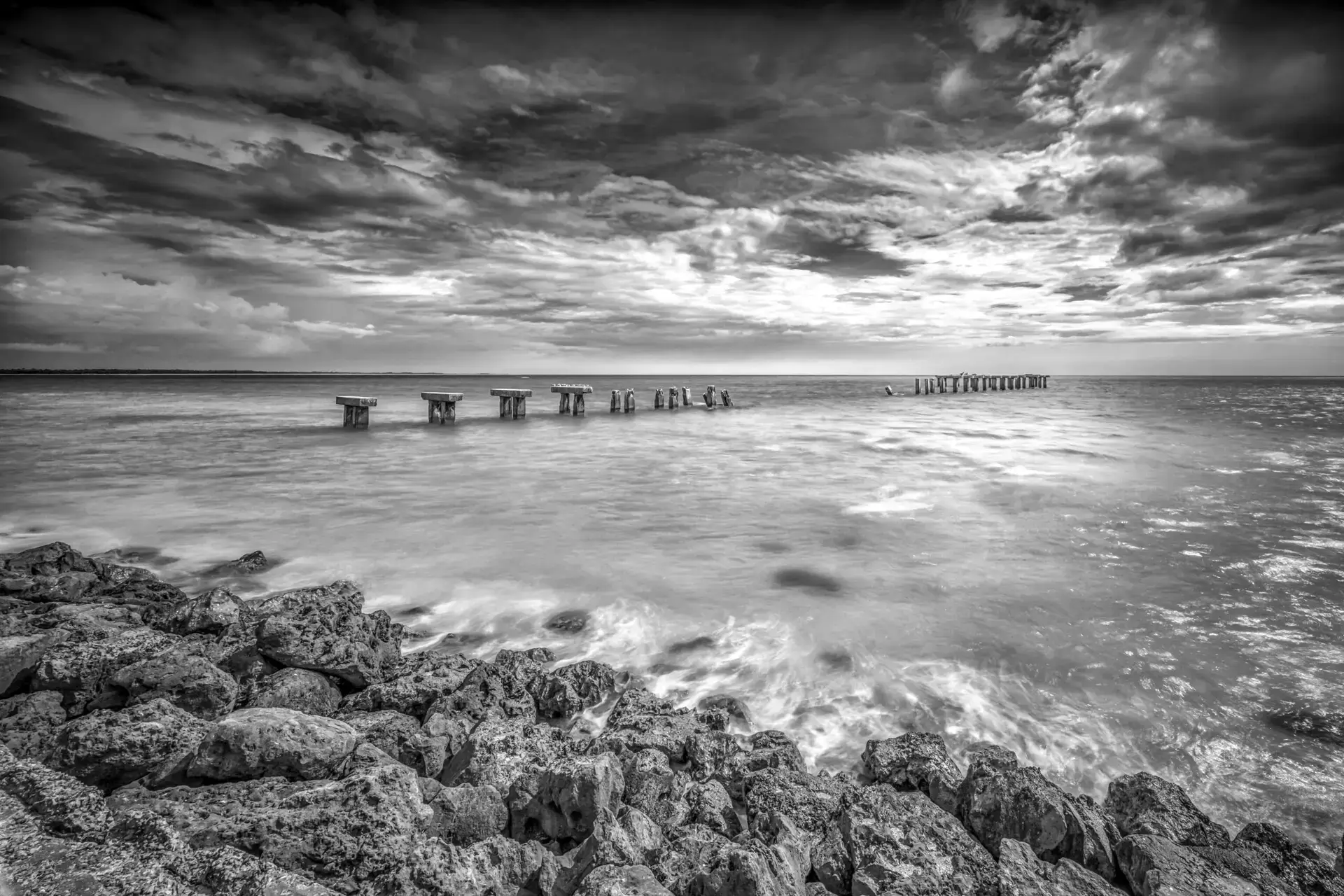 Abandoned pier over calm waters