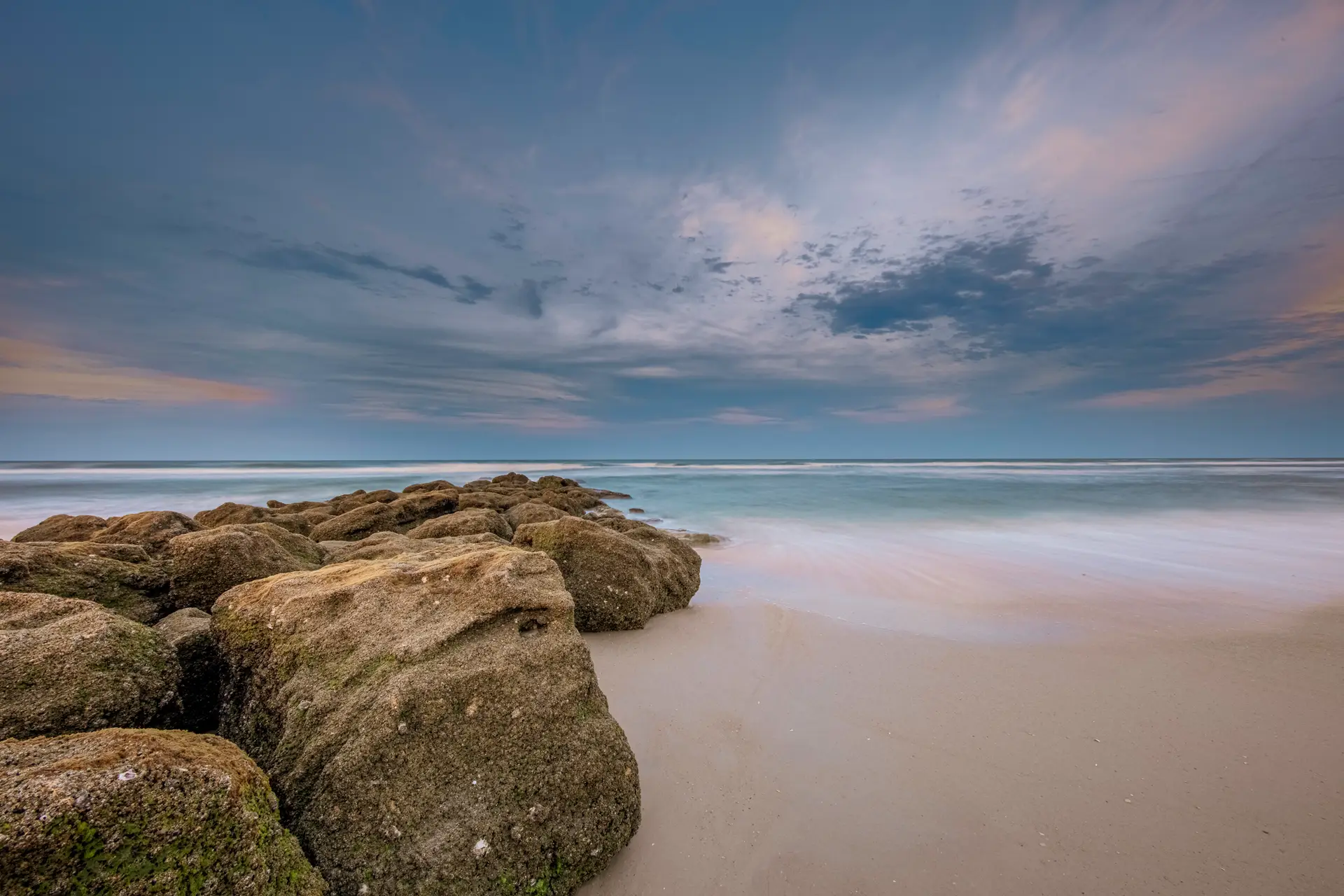 Serene beach with rocky shoreline