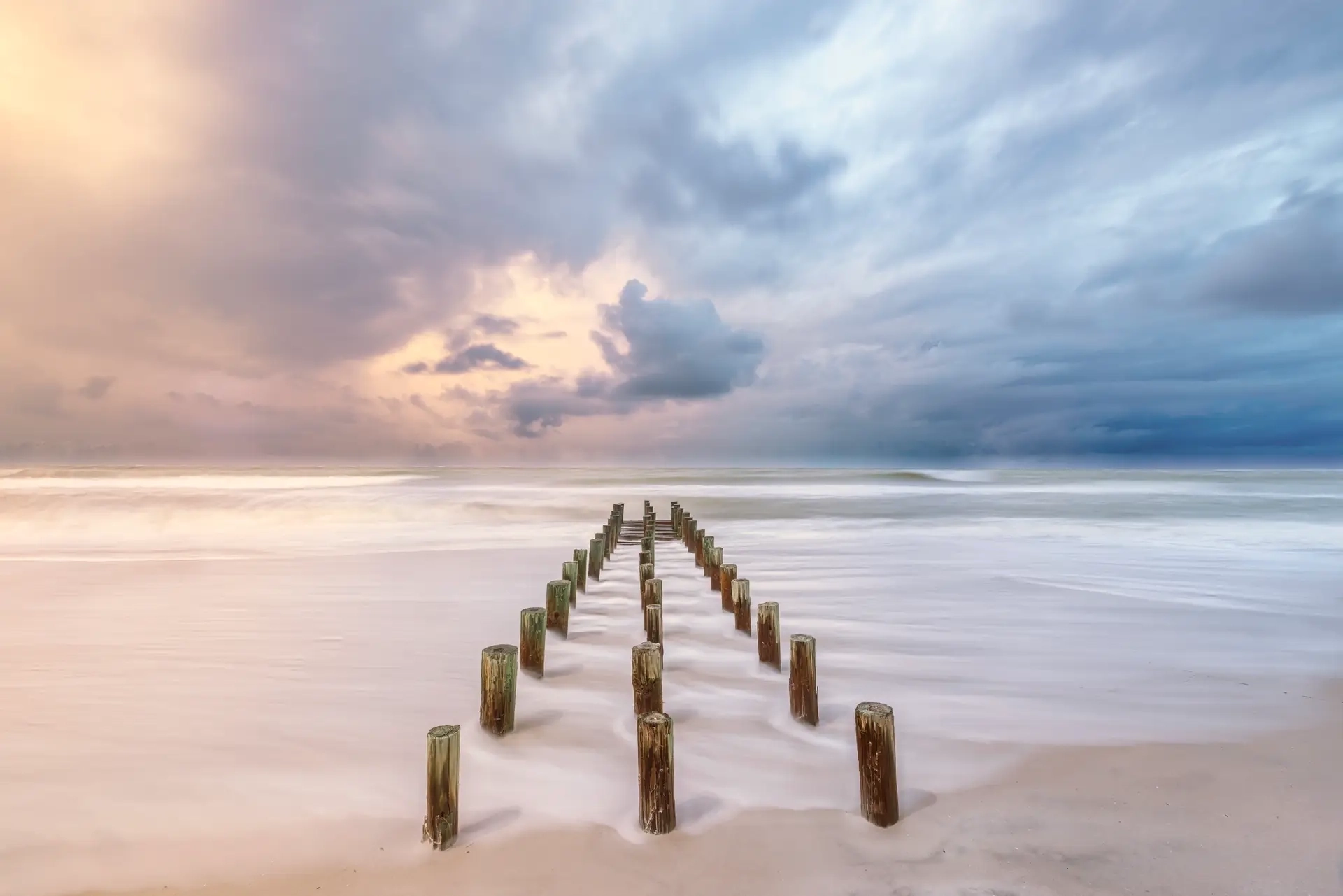 Serene beach with wooden posts
