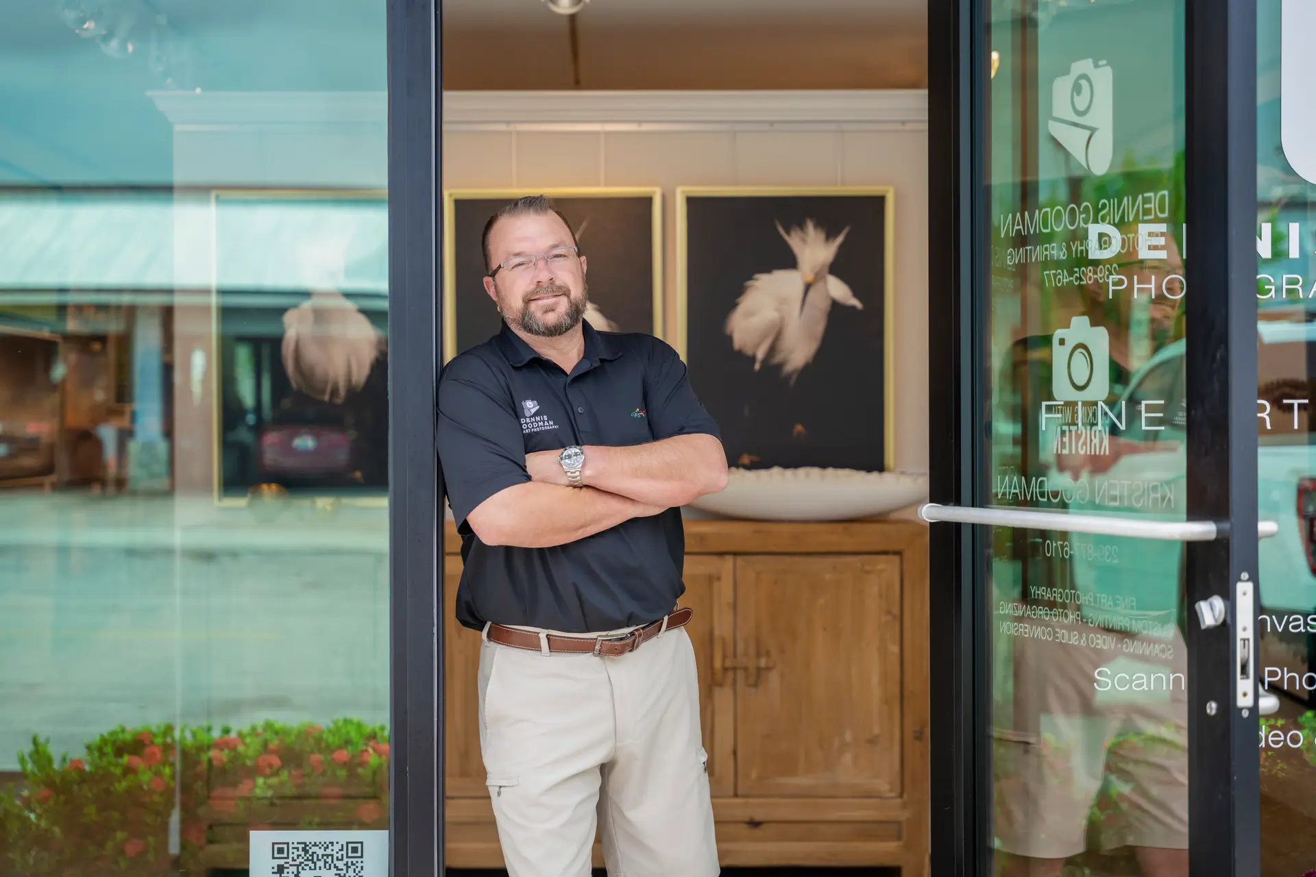 Dennis Goodman standing at gallery entrance.