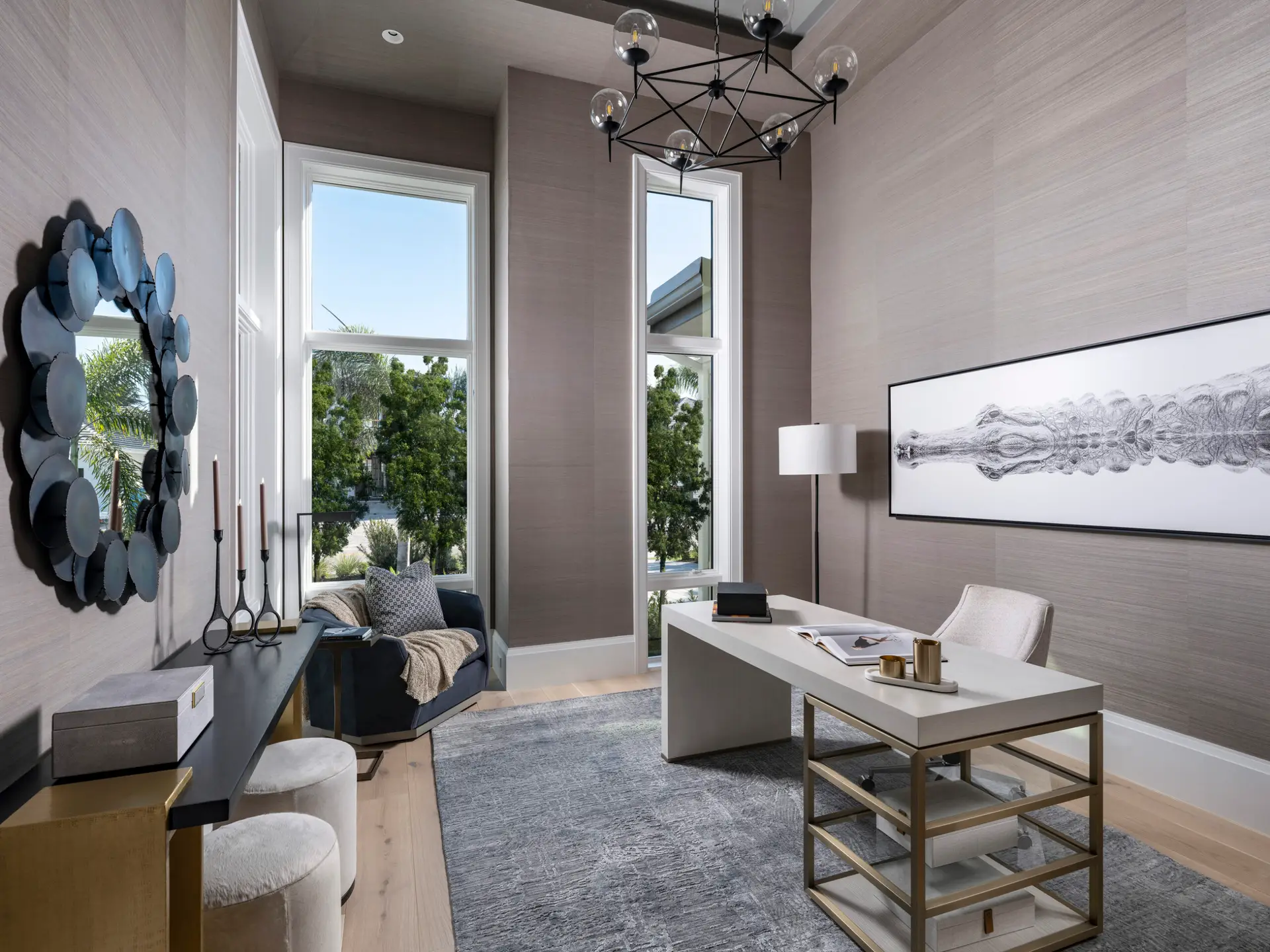 Modern office with tall windows and elegant decor.