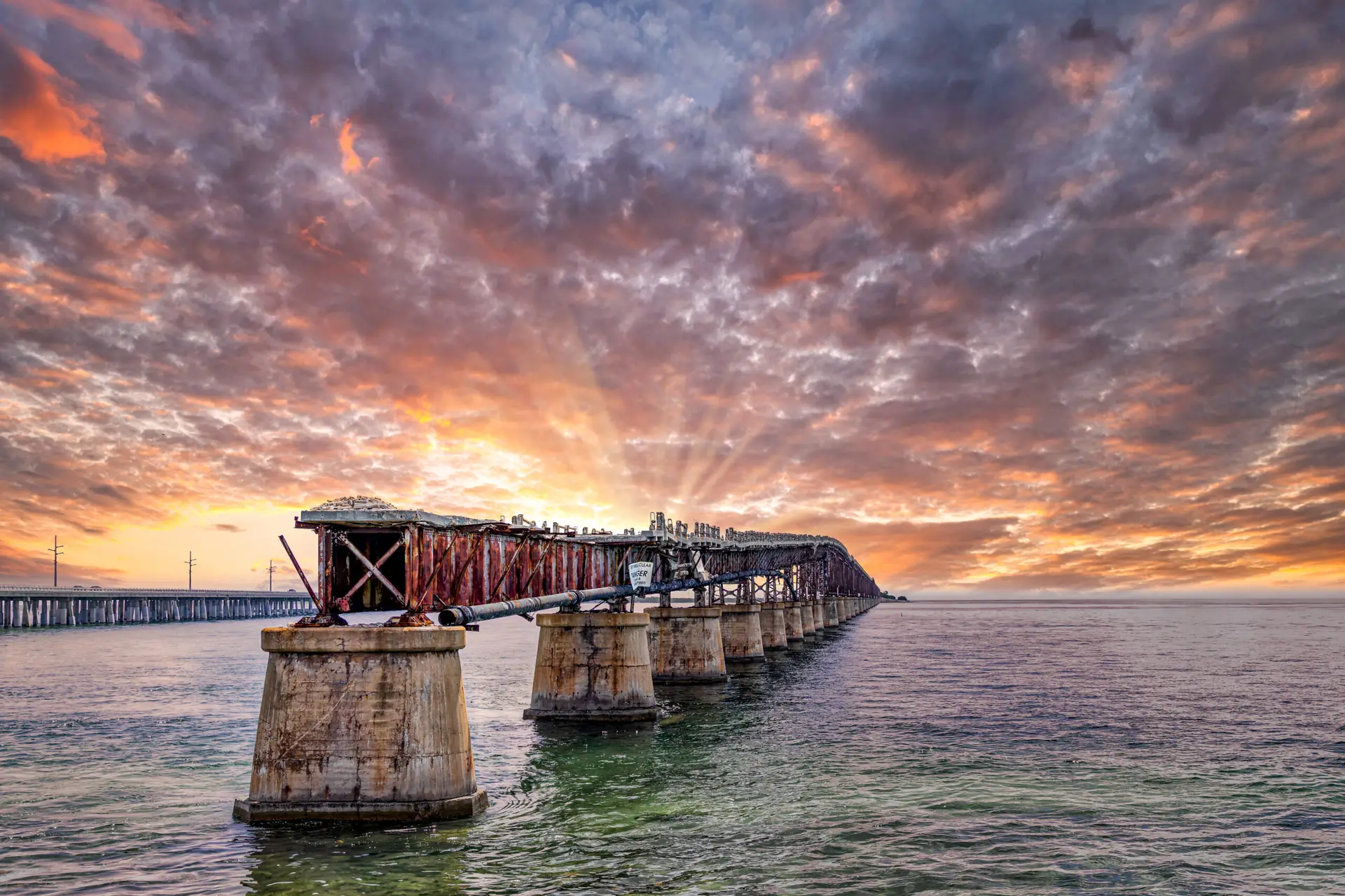 Sunset over a weathered pier.