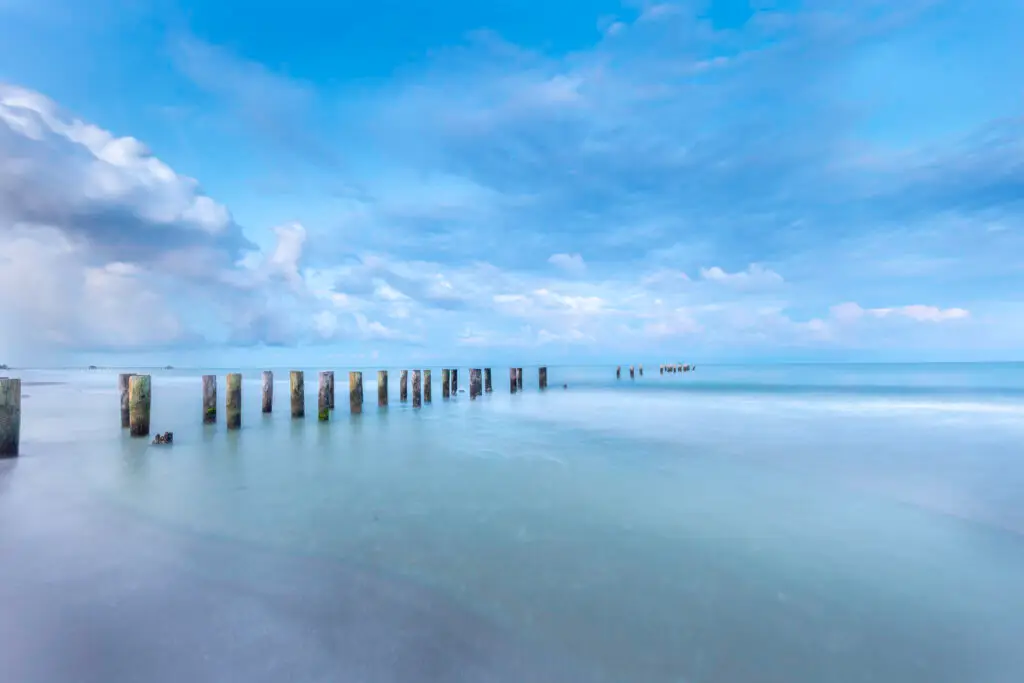 Serene beach with wooden pilings