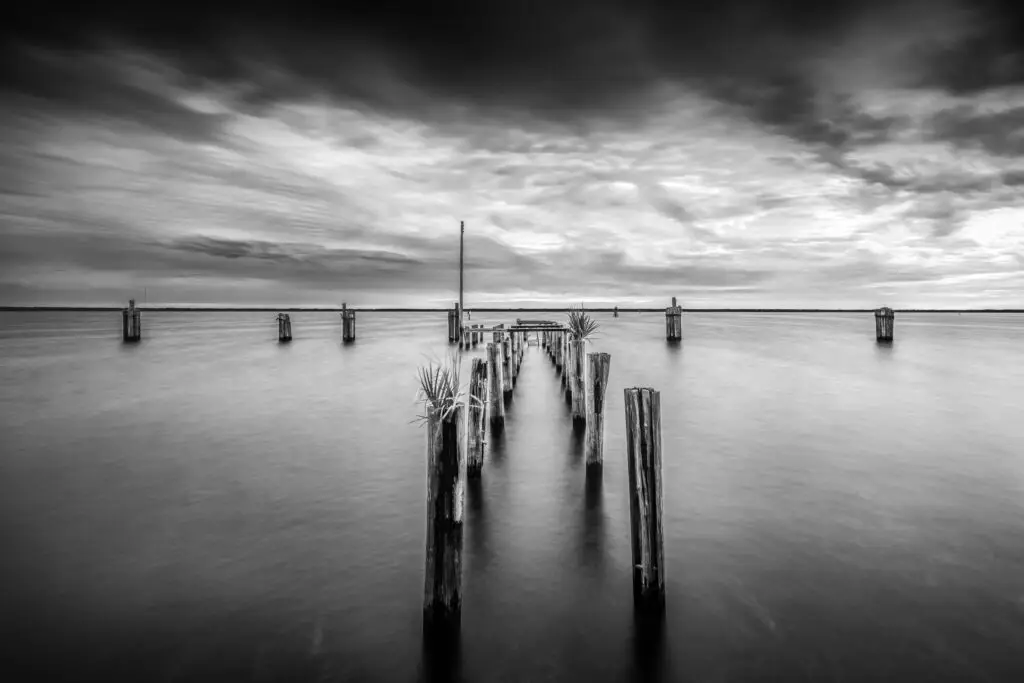 Abandoned pier in tranquil waters.