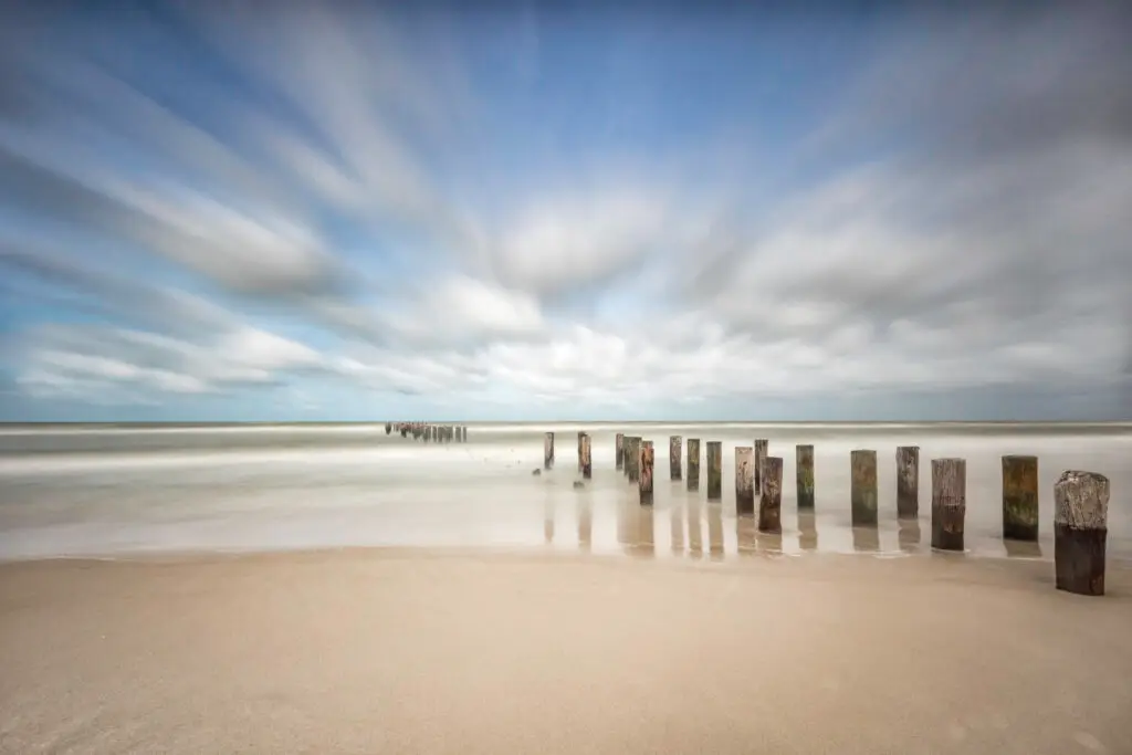 Serene beach with weathered wooden posts
