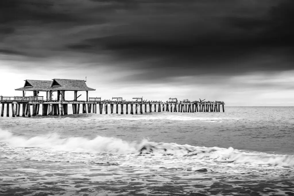 Black and white pier over ocean