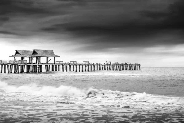 Black and white pier over ocean