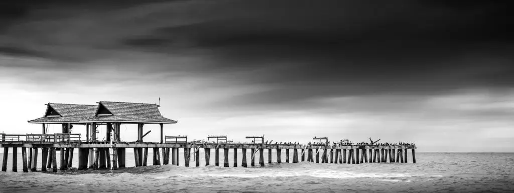 Black and white pier over water