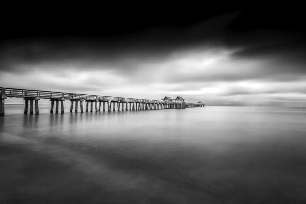 Serene black and white pier scene